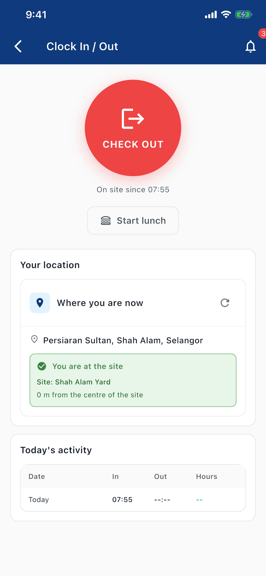 The Clock In / Out screen mid-shift: a large red CHECK OUT button over "On site since 07:55", with a Start lunch action beneath it. A location card reads "Where you are now — Persiaran Sultan, Shah Alam, Selangor" and confirms in green "You are at the site", naming Shah Alam Yard at 0 m from the centre. Today's activity shows one row: in at 07:55, out still blank.